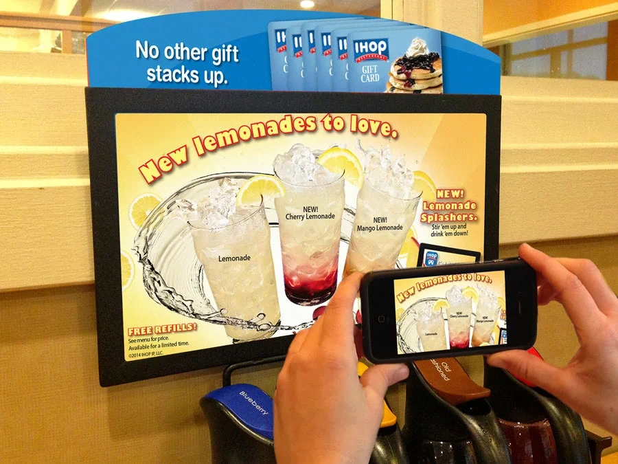 Phone scanning the IHOP table tent ad for new lemonades to start the AR game