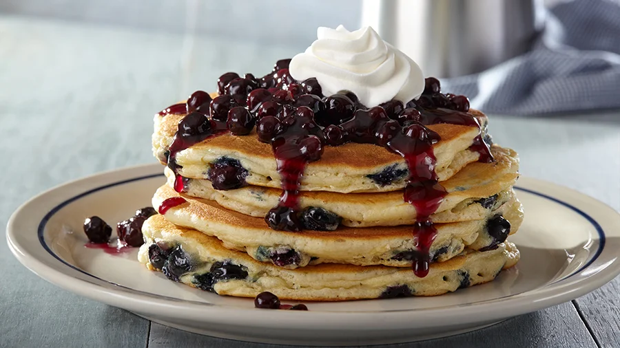 Blueberry pancakes topped with blueberry compote and whipped cream