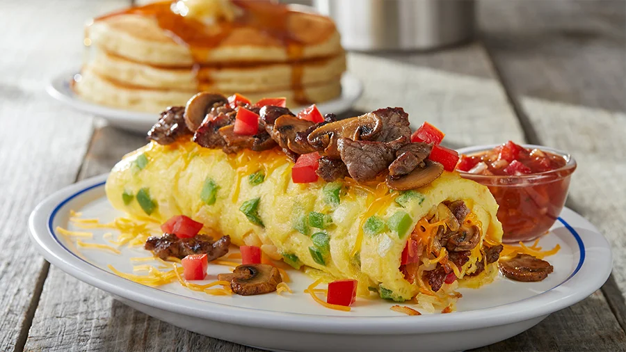 Steak omelette with mushrooms, peppers and cheese, with pancakes