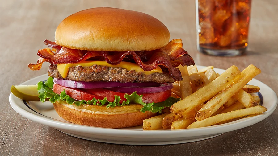 Bacon cheeseburger with lettuce, tomato and onion, served with fries
