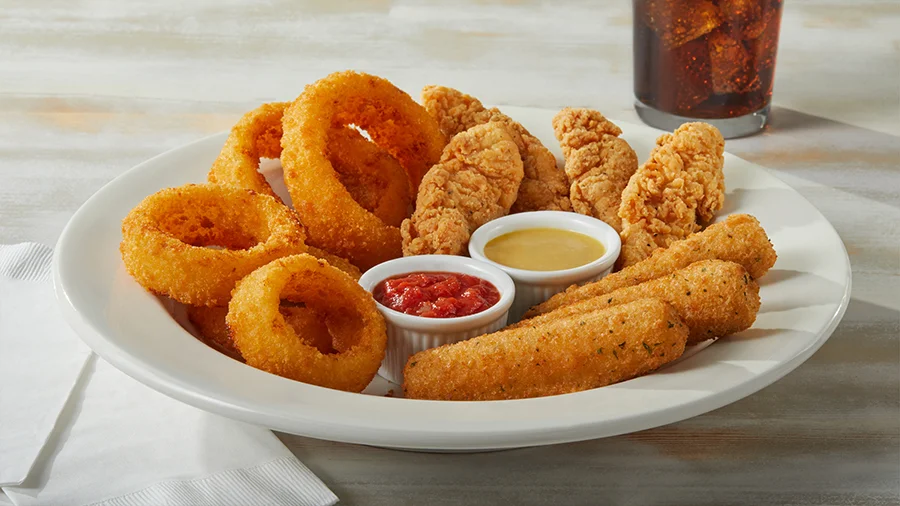 Appetizer sampler: onion rings and chicken strips with dipping sauces