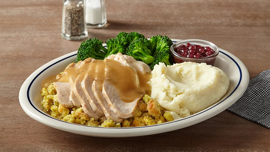 Roast turkey with gravy, mashed potatoes, stuffing, broccoli and cranberry sauce