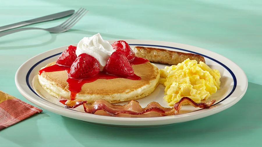 Kids' strawberry pancake with scrambled eggs and bacon