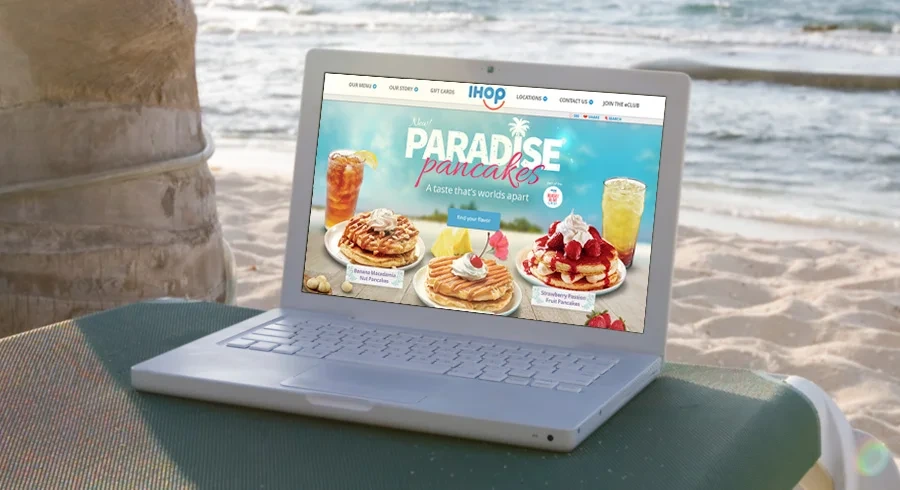Paradise Pancakes homepage on a laptop on the beach