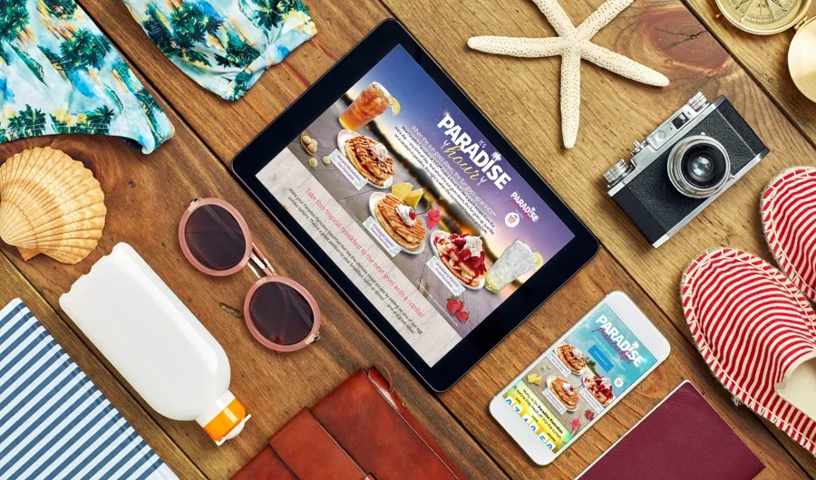 Paradise Pancakes page on a tablet on a striped beach towel with sunglasses and a starfish