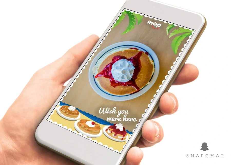 "Wish you were here" Snapchat filter on a phone over Paradise Pancakes